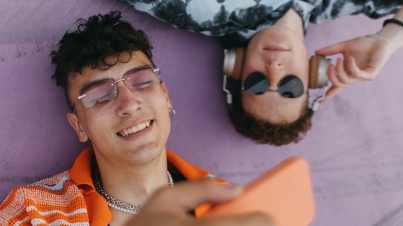 two young men looking at mobile