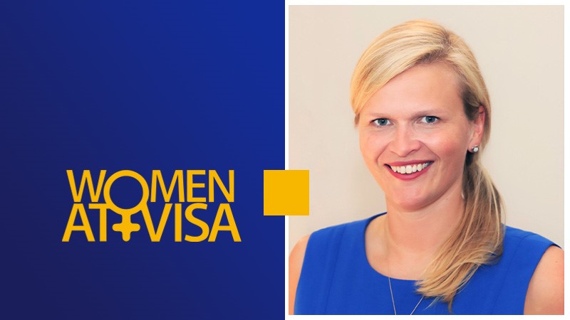 Portrait of Visa Employee Daniela Zdunek next to Women at Visa writing