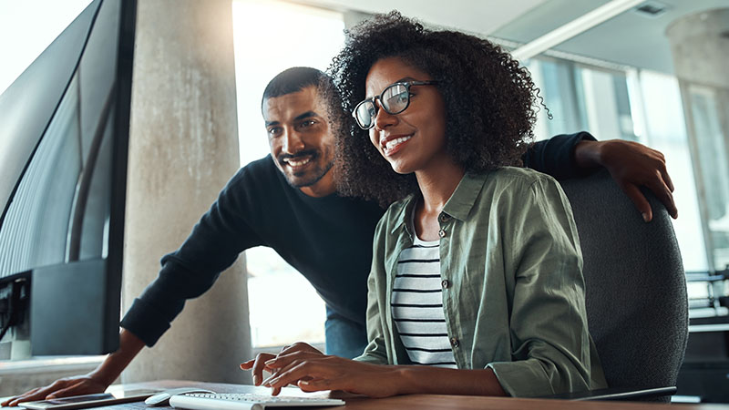 Woman and man in front of a computer