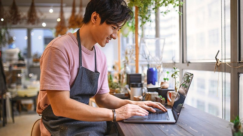 Smiling man on laptop