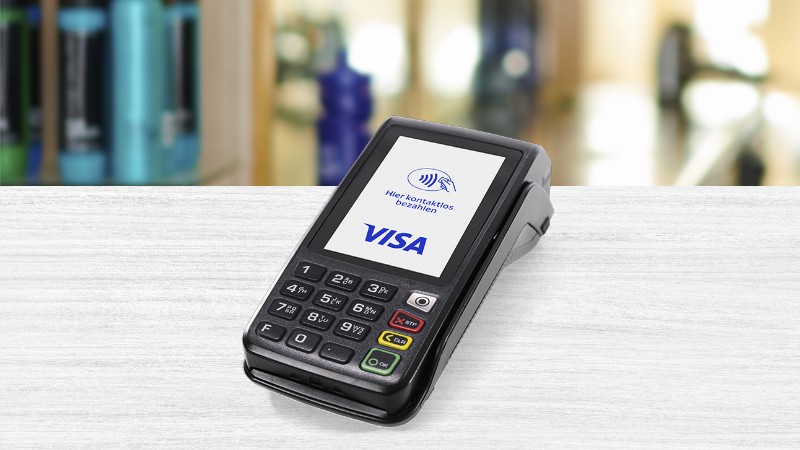 Payment terminal on a desk with visa logo