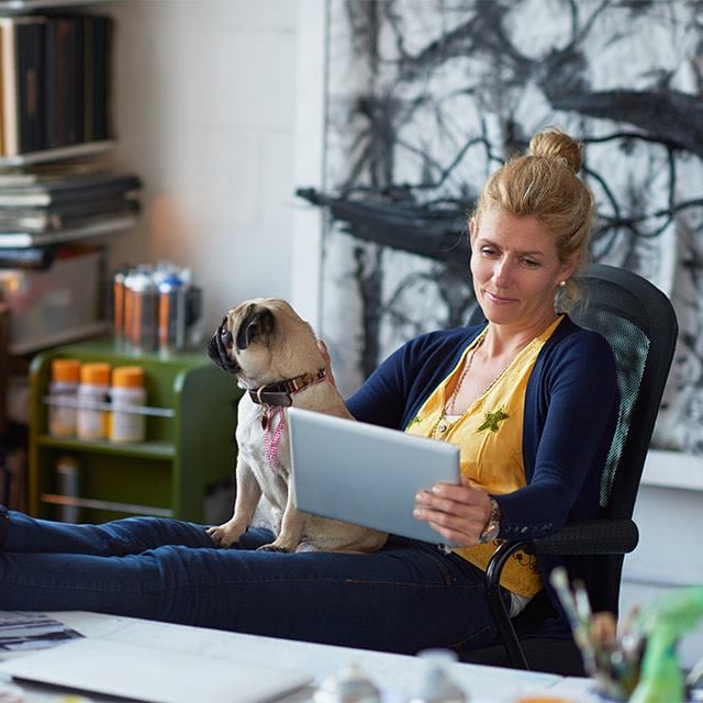 women using tablet with dog